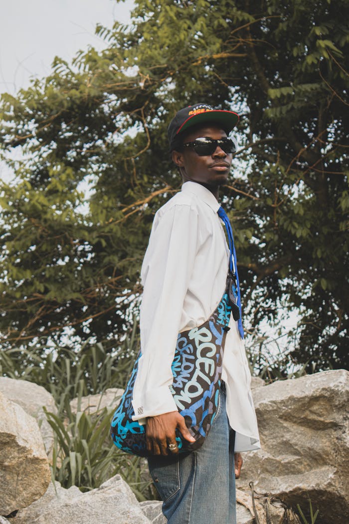 Man in Baseball Cap, Blue Tie and Jeans